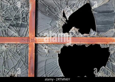Broken window pane of abandoned factory. Economic crisis. Close-up.  Valgrisenche. Italy. Stock Photo