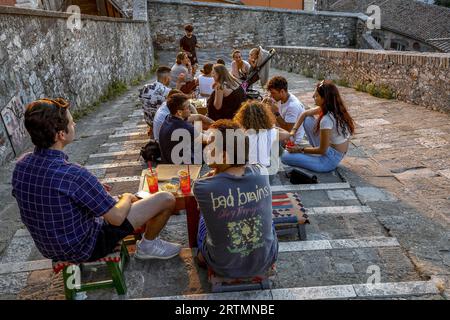 Young people sitting in a bar located on an urban staircase in Perugia, Umbria, Italy Stock Photo