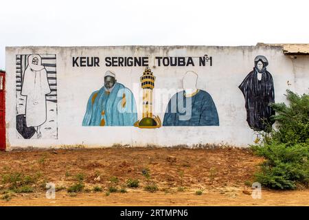 Wall with pictures of mouride muslim spiritual leaders in Tawafall, Senegal Stock Photo