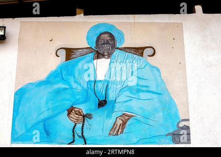 Wall with pictures of mouride muslim spiritual leaders in Tawafall, Senegal Stock Photo