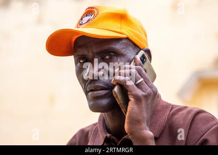Man using a cell phone in Thies, Senegal Stock Photo