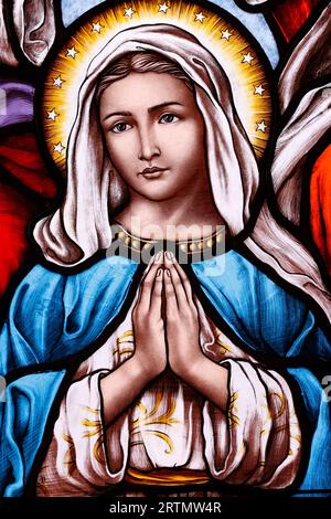 Song Vinh catholic church.  Stained glass window.  Virgin Mary praying.  Vietnam. Stock Photo