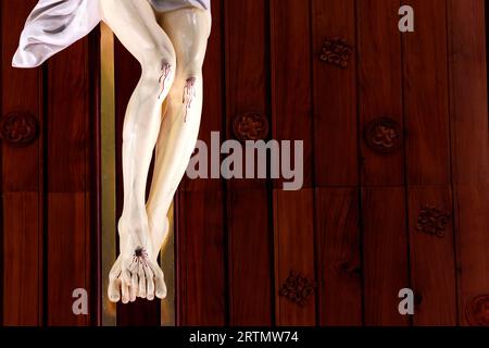 Song Vinh catholic church.  The crucifixion. Jesus on the cross. Detail on legs.  Vietnam. Stock Photo