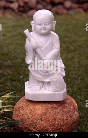 Linh Chieu Zen Monastery. Young buddhist monk in garden. Marble statue.  Vung Tau. Vietnam. Stock Photo