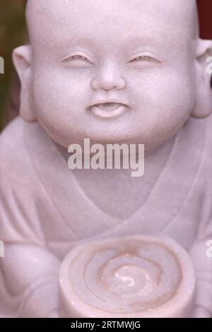 Linh Chieu Zen Monastery. Young buddhist monk in garden. Marble statue.  Vung Tau. Vietnam. Stock Photo