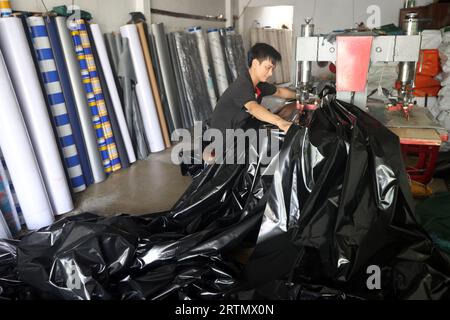 Man working in a factory. Sewing machine Ho Chi Minh city. Vietnam. Stock Photo