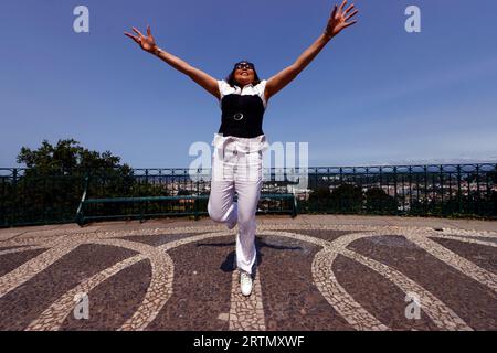 Happy  smiling woman jumping. Stock Photo
