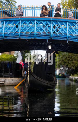 EDITORIAL USE ONLY Two cloaked figures operate a traditional Venetian Gondola in Little Venice to celebrate the launch of the new 20th Century Studios film, A Haunting in Venice. Picture date: Thursday September 14, 2023. Stock Photo