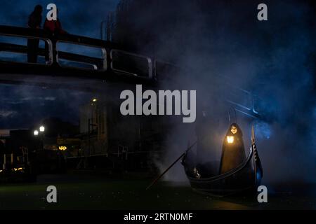 EDITORIAL USE ONLY Two cloaked figures operate a traditional Venetian Gondola in Camden Lock to celebrate the launch of the new 20th Century Studios film, A Haunting in Venice. Picture date: Thursday September 14, 2023. Stock Photo