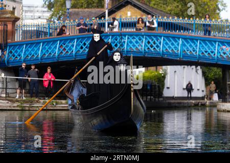 EDITORIAL USE ONLY Two cloaked figures operate a traditional Venetian Gondola in Little Venice to celebrate the launch of the new 20th Century Studios film, A Haunting in Venice. Picture date: Thursday September 14, 2023. Stock Photo