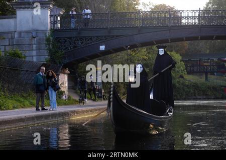 EDITORIAL USE ONLY Two cloaked figures operate a traditional Venetian Gondola on the Regents Canal to celebrate the launch of the new 20th Century Studios film, A Haunting in Venice. Picture date: Thursday September 14, 2023. Stock Photo