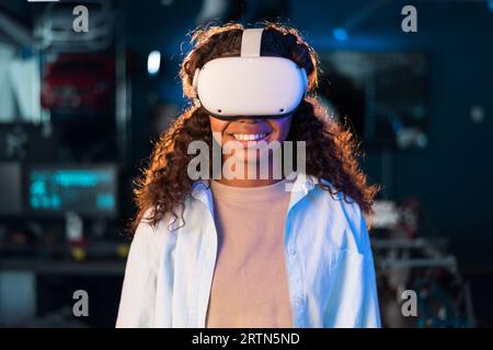Portrait of a black young smiling girl in VR glasses Stock Photo