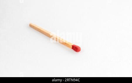 Close up of match on white. Single red match stick. Stock Photo