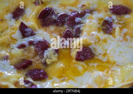Close up homemade scrambled fried egg with garlic sausages. Traditional morning breakfast food. Sucuklu Yumurta is at Turkish langıuage. Stock Photo