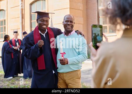 African American graduated student making photo with his family outdoors Stock Photo