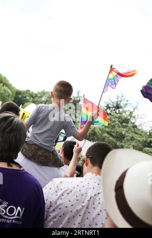 Back of child's head holding flag at Oxford Pride protest event June 2013 Stock Photo