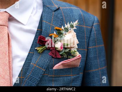 Wedding favour groom suit flowers on lapel boutonniere Stock Photo
