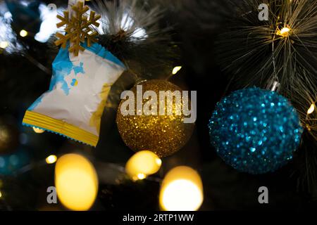 Festive Christmas tree with bokeh lights. yellow and blue Christmas balls. Abstract festive background in the colors of the Ukrainian flag. Stop the w Stock Photo