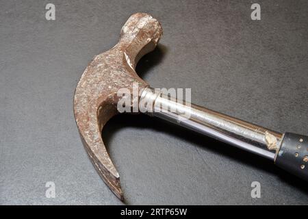nail hammer head on black wooden table in close up Stock Photo