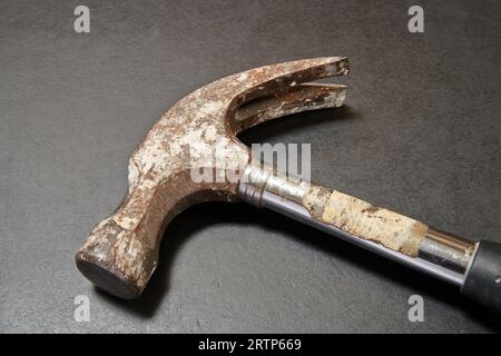 nail hammer head on black wooden table in close up Stock Photo