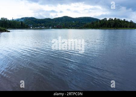 Cerulean waters look molten on the placid lake in summer cottage country Stock Photo