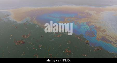 Fuel or Diesel spillages spreading across the water polluting the sea Stock Photo