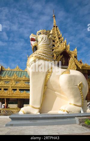 YANGON, MYANMAR - DECEMBER 17, 2016: At the foot of a giant sculpture of a dragon. A fragment of the entrance to the Shwedagon pagoda. Yangon, Myanmar Stock Photo
