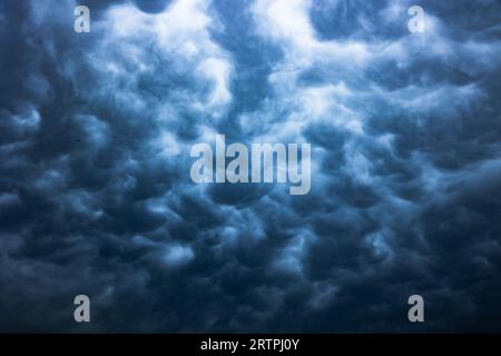 Dramatic mammatus clouds background photo. Full frame view of mammatus clouds. Stock Photo