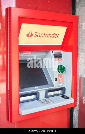 Viladecans, Spain - September 14, 2023: Santander bank ATM with its advertising outside the bank office. Stock Photo