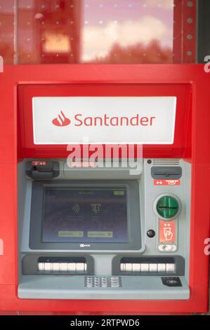 Viladecans, Spain - September 14, 2023: Santander bank ATM with its advertising outside the bank office. Stock Photo