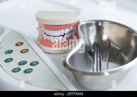 dental health and treatment - dentist tools with teeth model in