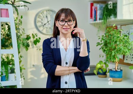 Portrait of confident middle-aged woman in office Stock Photo