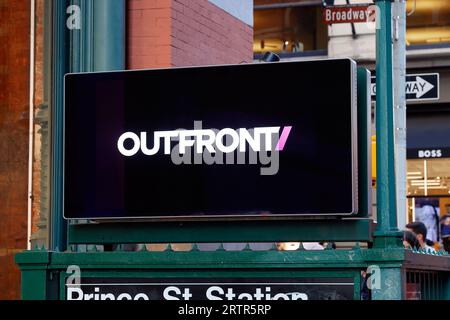 Digital billboard signage at a NYC Subway entrance display the logo of Outfront Media, a digital outdoor advertising and media company. Stock Photo