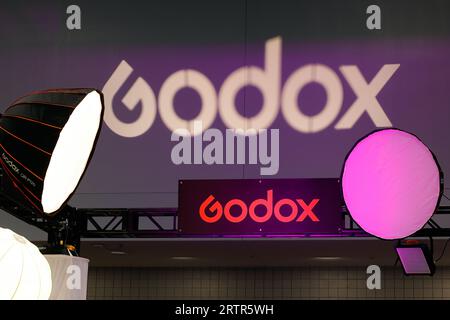 Signage for Godox photographic studio lighting equipment at a trade show exhibition. Stock Photo