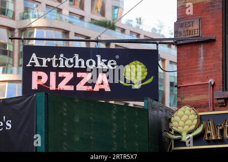 Signage for Artichoke Basille's Pizza, on 10th Ave, New York City in Manhattan's Chelsea neighborhood. Stock Photo