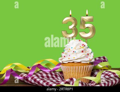 Birthday Cake With Candle Number 35 - On Green Background. Stock Photo