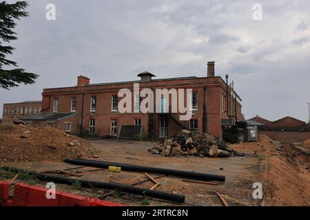 The site of the former Royal Navy Hospital, Haslar, is the subject of a £150 million redevelopment. Most of the buildings on the site are Grade 2 listed buildings and were built in the Victorian and Edwardian eras. This photograph shows one of the buildings around which groundwork is being done. Stock Photo