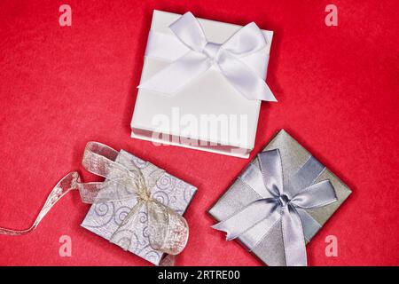 Various Gift Boxes with Ribbon and Bows isolated on Red Stock Photo