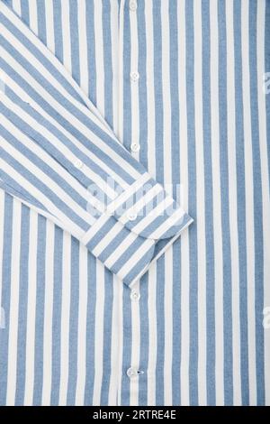 Striped men's shirt. Sleeve close up. White and blue striped fabric texture background Stock Photo