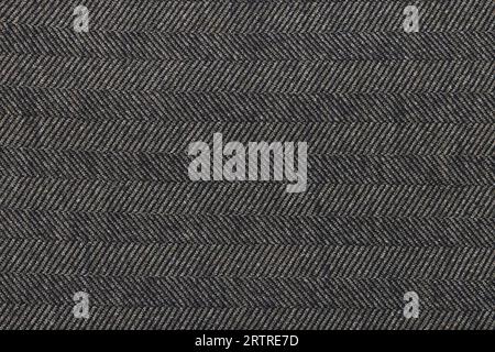 Classic tweed, Wool Background Texture. Coat close-up. Brown woolen fabric striped zigzag. Herringbone tweed, Wool Background Texture. Coat close-up. Stock Photo