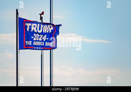 A Trump 2024 flag flies at a pier on Coden Beach, Sept. 11, 2023, in Coden, Alabama. The flag includes the slogan, “Take America Back.” Stock Photo
