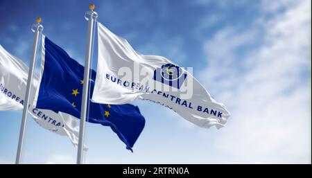 Frankfurt, DE, March 18 2023: Flags of the European Central Bank and European Union waving in the wind on a clear day. Illustrative editorial 3d illus Stock Photo
