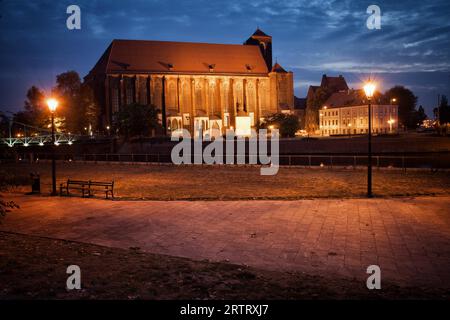 City of Wroclaw in Poland, Church of Our Lady on the Sand by night, 14th century Gothic architecture, alley in Ostrow Tumski Stock Photo