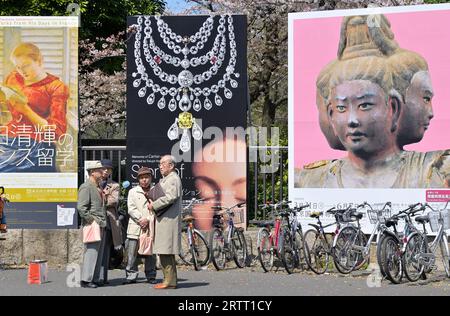 Japanese elderly men standing in front of a billboard at Tokyo National Museum, Tokyo Ueno, Japan JP Stock Photo