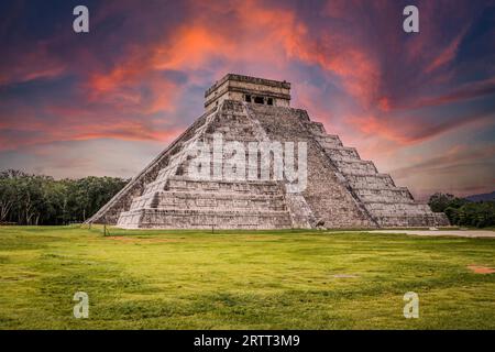 Beautiful clouds at sunrise over the famous Maya pyramid in Yucatan, Mexico that attracts millions of visitors Stock Photo