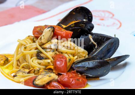 Spaghetti with mussels and cherry tomatoes. Stock Photo