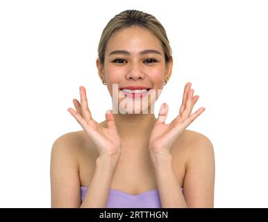 A woman's hand reaching for her face. Her skin is illuminated by soft lighting, adding a sense of mystery to her gesture. Stock Photo