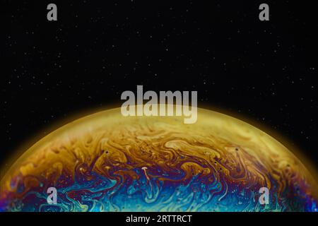 Soap bubble as a virtual planet space.. Multi-colored alien futuristic planet. Stock Photo