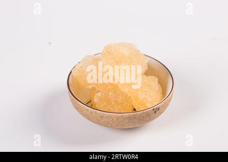 Old Rock sugar in a bowl on white background. Stock Photo