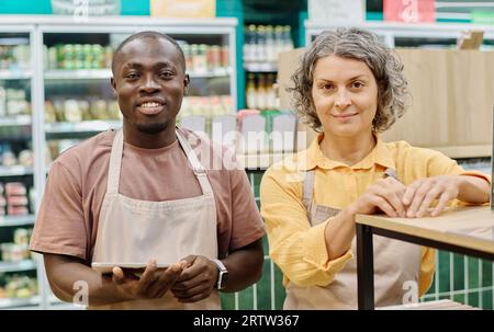 Portrait of workers of supermarket using digital tablet while working in team Stock Photo